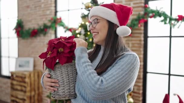 Young Hispanic Woman Holding Christmas Plant Home — Stock Video