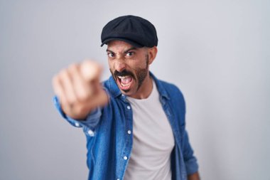 Hispanic man with beard standing over isolated background pointing displeased and frustrated to the camera, angry and furious with you 