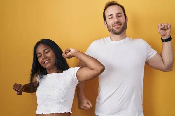 Interracial Couple Standing Yellow Background Stretching Back Tired Relaxed Sleepy — Stock Photo, Image