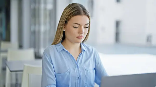 Young blonde woman business worker using laptop working at office