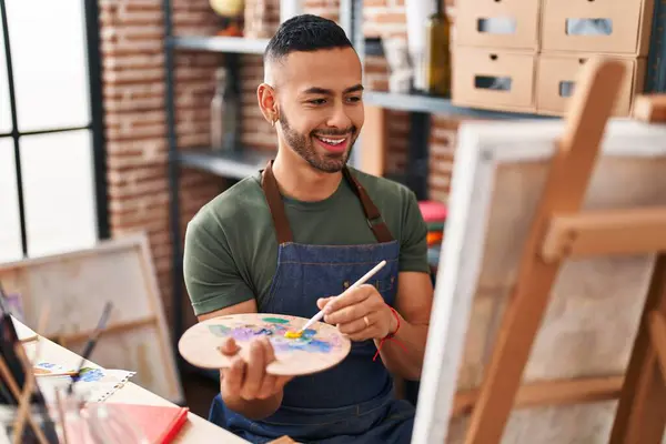 African american man artist smiling confident drawing at art studio
