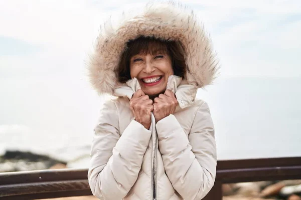 Middle Age Woman Smiling Confident Freezing Seaside — Zdjęcie stockowe