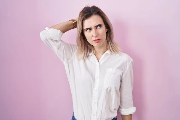 Young Beautiful Woman Standing Pink Background Confuse Wondering Question Uncertain — Stockfoto