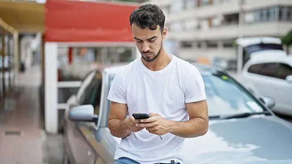 Young Hispanic Man Using Smartphone Sitting Car Street — Foto de Stock