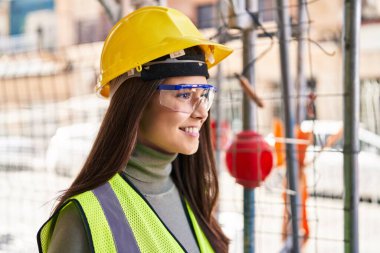 Young beautiful hispanic woman architect smiling confident standing at street