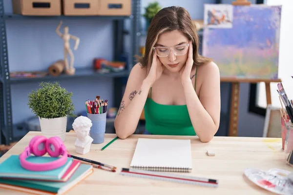 Young woman artist stressed drawing at art studio
