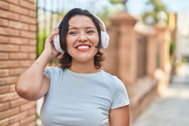 Sokakta müzik dinleyen genç İspanyol kadın.