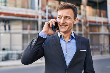 Young man business worker smiling confident talking on smartphone at street