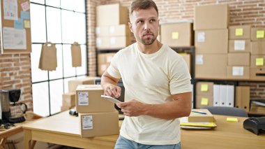 Young man ecommerce business worker using smartphone at office