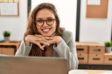 Young beautiful hispanic woman business worker using laptop working at office