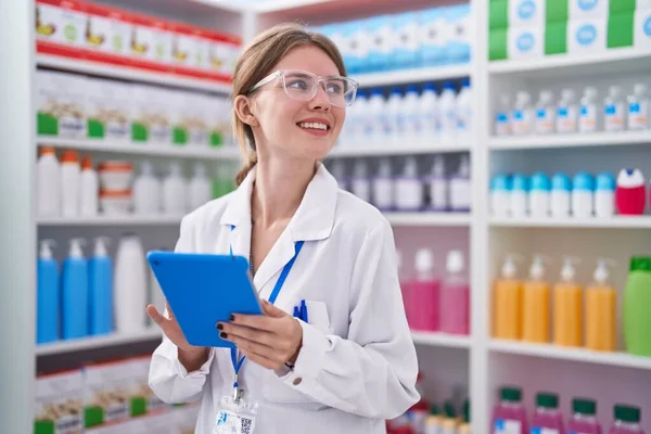 Joven Mujer Rubia Farmacéutica Sonriendo Confiada Usando Touchpad Farmacia —  Fotos de Stock