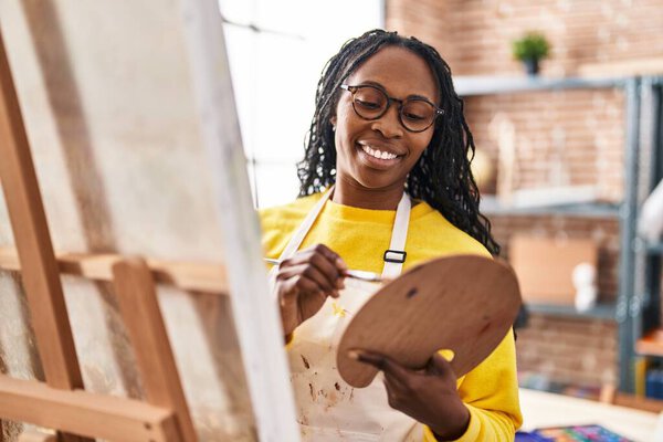 African american woman artist smiling confident drawing at art studio