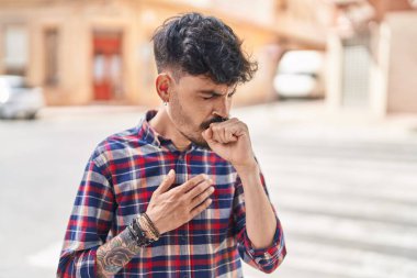 Sokakta öksüren genç İspanyol.