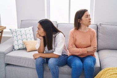 Two women mother and daughter arguing at home