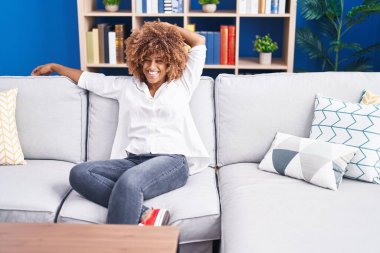 African american woman smiling confident sitting on sofa at home