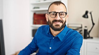 Young hispanic man business worker using computer working at office