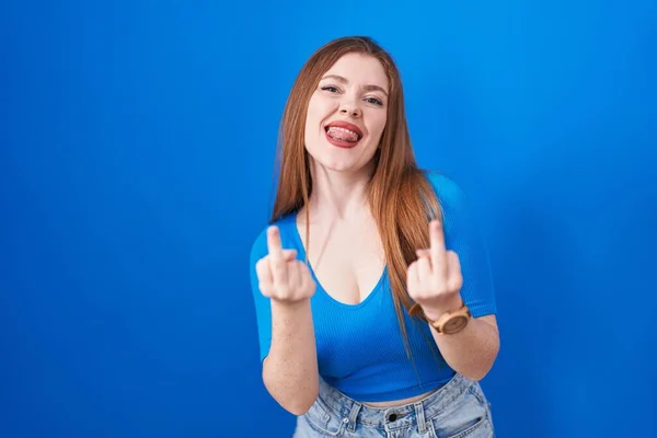 Redhead Woman Standing Blue Background Showing Middle Finger Doing Fuck — стоковое фото