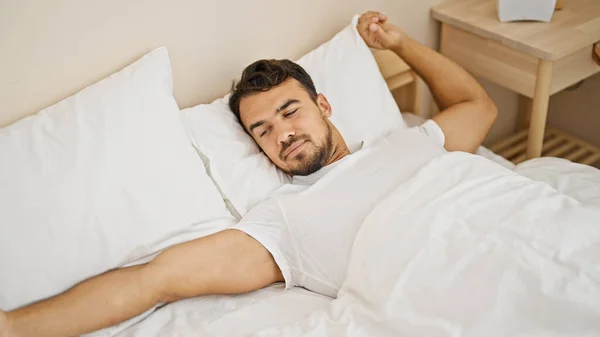 Young Hispanic Man Waking Stretching Arms Bedroom — Stockfoto