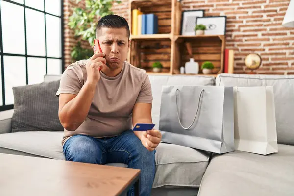 Hispanic Young Man Doing Payment Credit Card Phone Puffing Cheeks — Stock Photo, Image
