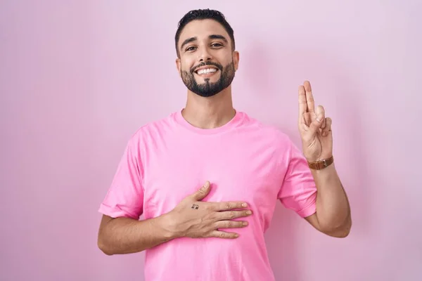 Hispanic Young Man Standing Pink Background Smiling Swearing Hand Chest — Stock Photo, Image
