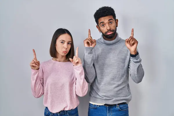 Young Hispanic Couple Standing Together Pointing Looking Sad Upset Indicating — Stock Photo, Image
