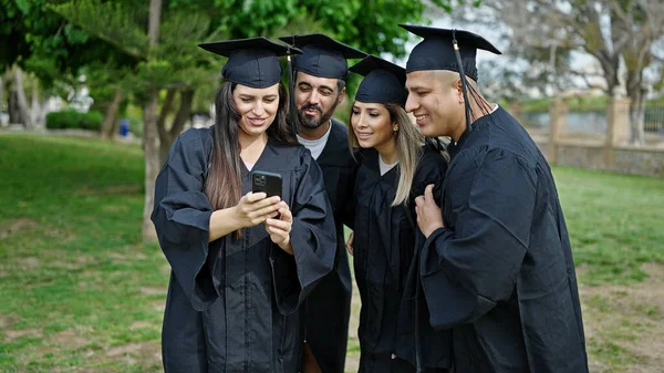 Group of people students graduated using smartphone at university campus