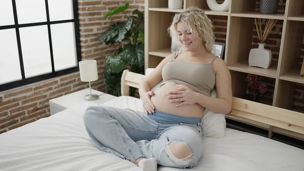 Young Pregnant Woman Touching Belly Sitting Bed Bedroom — стоковое фото