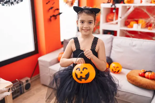 Adorable Hispanic Girl Wearing Halloween Costume Holding Pumpkin Basket Home — 스톡 사진