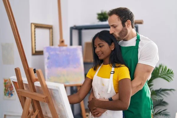 stock image Man and woman artist couple hugging each other drawing at art studio