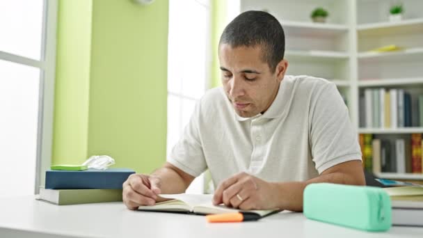 Young Hispanic Man Student Reading Book Studying Library University — Stock videók