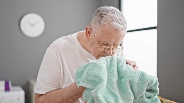 Middle Age Grey Haired Man Holding Basket Smelling Clean Clothes — Vídeos de Stock