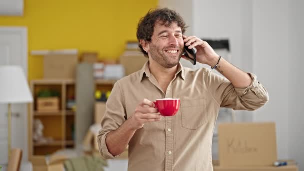 Young Hispanic Man Talking Smartphone Drinking Coffee New Home — Video Stock