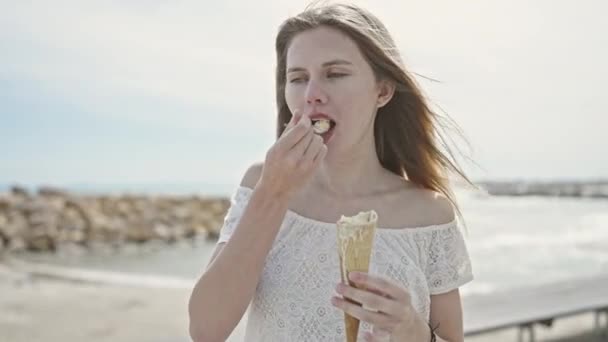 Młoda Blondynka Turystka Uśmiecha Się Pewnie Jedząc Lody Nad Morzem — Wideo stockowe