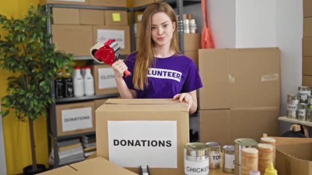 Joven Mujer Rubia Voluntaria Sonriendo Confiada Sosteniendo Cinta Embalaje Centro — Vídeos de Stock
