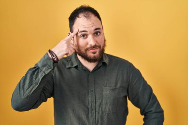 Ayrıca sarı arka planda dikilen sakallı, tek parmakla kafasını gösteren, harika bir fikir ya da düşünce sahibi, iyi bir hafızası olan İspanyol bir adam. 