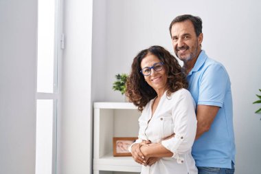 Man and woman couple hugging each others at home