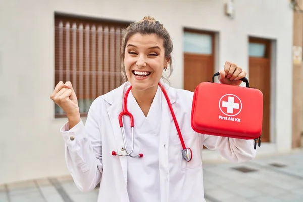 Young Doctor Woman Holding First Aid Kit Screaming Proud Celebrating — Stockfoto