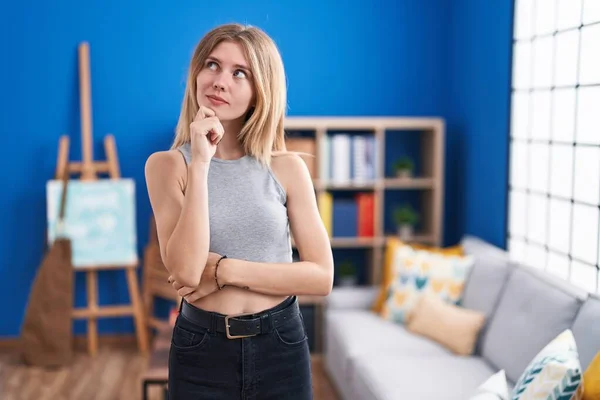 Blonde Caucasian Woman Standing Living Room Serious Face Thinking Question — Stock Photo, Image