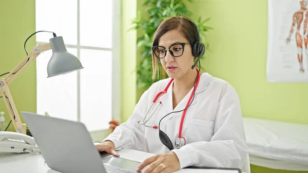 Middle eastern woman doctor doing online appointment at clinic