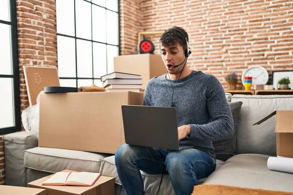 Jonge Spaanse Man Werkt Met Laptop Nieuw Huis Bang Verbaasd — Stockfoto
