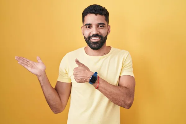 Hispanic Man Beard Standing Yellow Background Showing Palm Hand Doing — 스톡 사진