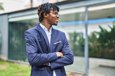 African american man executive smiling confident standing with arms crossed gesture at park