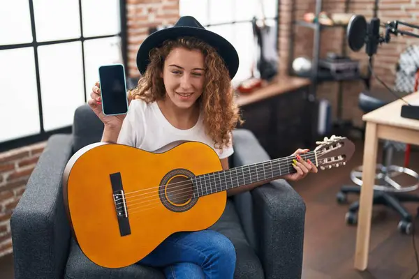 Young Caucasian Woman Playing Classic Guitar Music Studio Holding Smartphone — Stock Photo, Image