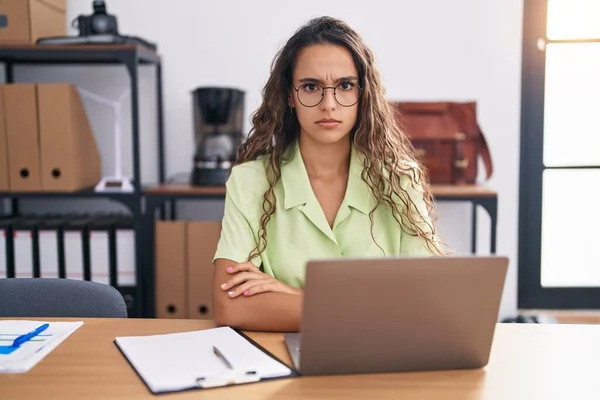 Young Hispanic Woman Working Office Wearing Glasses Skeptic Nervous Frowning — Stok fotoğraf