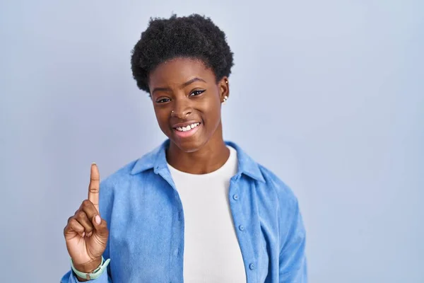African American Woman Standing Blue Background Showing Pointing Finger Number — Photo