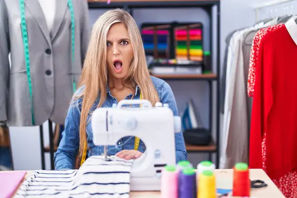Blonde Woman Dressmaker Designer Using Sew Machine Shock Face Looking — Stock Photo, Image