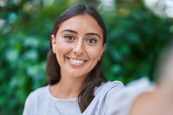 stock image Young beautiful hispanic woman smiling confident making selfie by camera at park