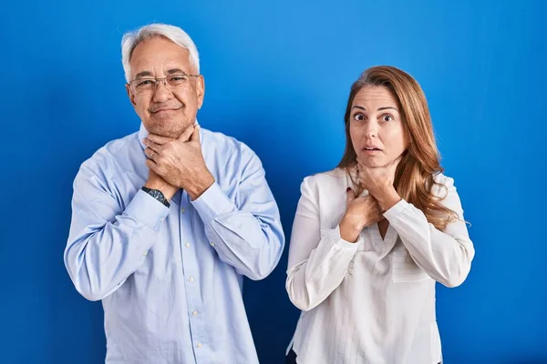 Middle Age Hispanic Couple Standing Blue Background Shouting Suffocate Because — Stock Photo, Image