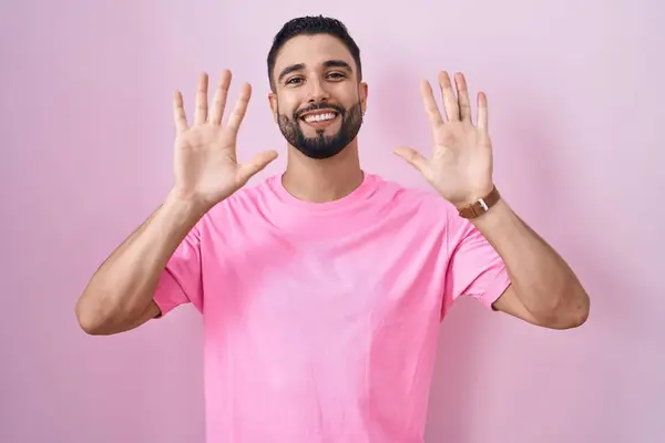 Hispanic Young Man Standing Pink Background Showing Pointing Fingers Number — Stock Photo, Image