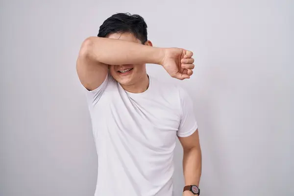 Young Asian Man Standing White Background Covering Eyes Arm Smiling — Stock Photo, Image